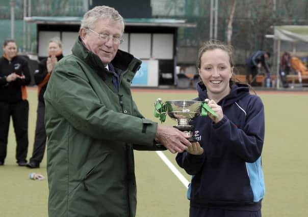 Ulster Elks' captain Gemma Frazer gets her hands in the Irish Senior Cup after beating Hermes 1-0 in Sunday's final in Dublin. Photo: Philip McCloy