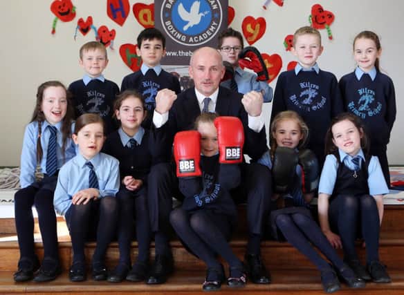 Barry McGuigan pictured with pupils from Kilrea Primary School. ©/Lorcan Doherty Photography