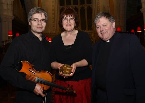 Dean William Morton, pictured with storyteller Liz Weir, and musician Ciaran Mulholland at their performance of 'All For The Dead Man's Penny' in St. Columb's Cathedral on Thursday night. INLS1315-117KM