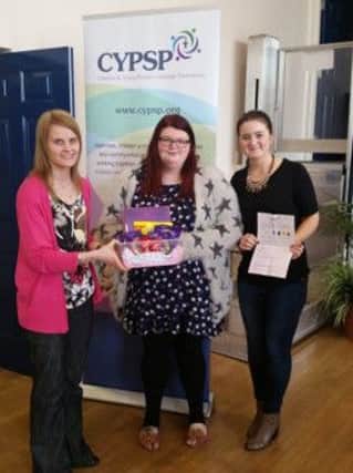 Winner receiving the Disability Fair Hamper pictured along with Sandra Anderson - Participation Development Officer and Gemma Lutton - Programme Support Officer.