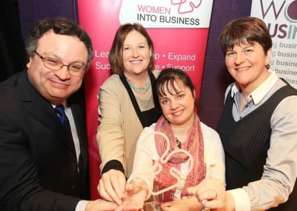 Marion Hull from Lisburn is presented with the Women into Business Award for Growth Potential by Employment and Learning Minister, Dr Stephen Farry and Enterprise, Trade and Investment Minister, Arlene Foster and Chief Executive of Women in Business Northern Ireland, Roseann Kelly.