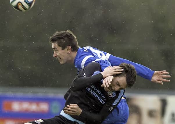 Mark Surgenor came off worst in this clash during Saturday's match at Ballinamallard - but the midfielder had the last laugh as he continued his rich vein of scoring form in games against the Fermanagh side. Picture: Press Eye.