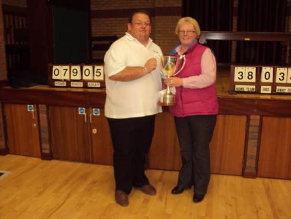 Paul Reid receiving the Zone Charity Cup on behalf of Ballinderry BC from Zone Treasurer, Patricia Halliday.