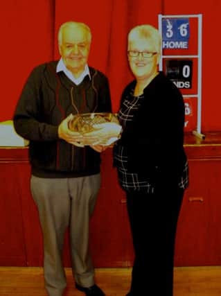 Edwin Patterson receiving the Zone Charity Rosebowl on behalf of Killaney BC from Mary Croot, Zone Secretary.