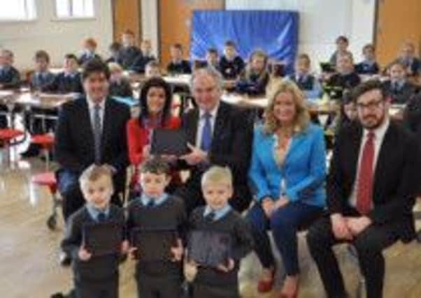 Children at Waringstown Primary School getting their new Ipads. Included is current principal Carl McCambley, former principal Gary Kennedy, Mr Ian Somerville and Mrs Sharon Williamson (School ICT Co-ordinators) and local MLA Jo-Anne Dobson..