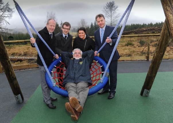 Cookstown councillor James McGarvey looks relaxed as he enjoys the facilities at the new Play-area at Davagh with Sean McGuigan, Graeme Major, Mary McKeown and Wilbert Buchanan