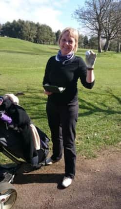 Caroline Watson makes sure to get her hole-in-one down on the scorecard after hitting an ace at the fourth hole at Edenmore Golf Club.