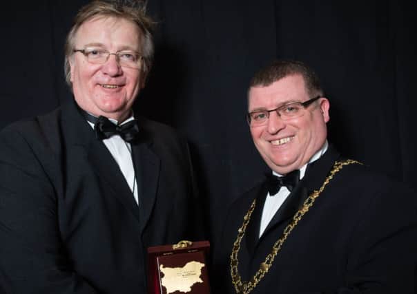 Former Larne councillor Alex Caldwell presents a plaque to outgoing Larne mayor Martin Wilson which he brought from the council of Careva Livada, in Bulgaria, to Larne. INLT 14-650-CON