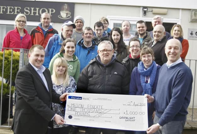 The team from Greenlight Gateway including members and trainees presentating Cathal O'Connell, Mellon Educate volunteer with a cheque for £1,000.  The money will be used to build schools in some of the poorest townships in South Africa. INBM15-15 KMA
