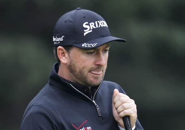 Graeme McDowell of Northern Ireland reacts after missing a putt on the 11th green during the 3rd round of the HSBC Champions golf tournament at the Sheshan International Golf Club in Shanghai, China, Saturday, Nov. 8, 2014. (AP Photo)