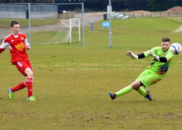 Carniny Youth U19 player, Shane McKernan slots past the Carrick Keeper for the second goal in their 3-1 win on Saturday.