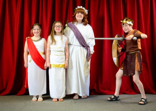 Rachel, Rebecca and Miss Mullen are spoils of war for Centurion Adam at Eden Primary School's Roman day. INCT 14-100-GR