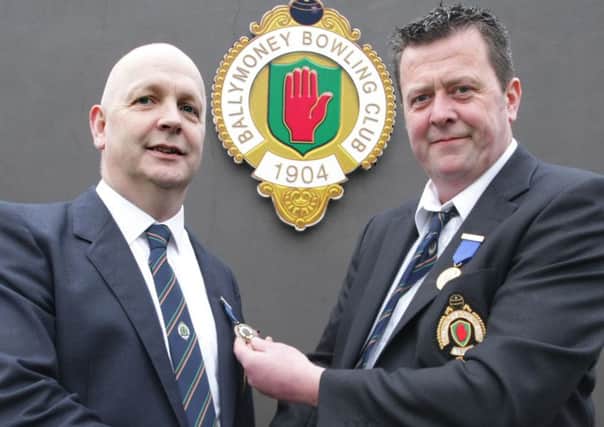 HAND OVER. Newly elected Ballymoney Outdoor Bowling Club President, Brian McAlary (left), receives his 'badge of office' from outgoing President Jim Martin.INBM15-15 009SC.