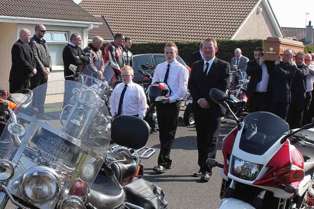 Charlie and Lewis Anderson, sons of the late David Anderson who was killed in a road traffic collision in Belfast, pictured at his funeral on Thursday. Over 200 bikers followed the funeral to Coleraine Cemetry. PICTURE: MARK JAMIESON.