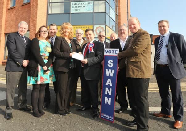 Robin Swann of the UUP hands in his election papers to Deputy Returning Officer Rea Kirk at the Ballymena Area Electoral Office last week. Included are local councillors and Election Agent Roy McLean. INBT 16-100JC