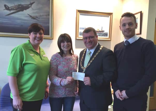 Former Mayor of Larne Martin Wilson presents a cheque for over £4000 to Carlee Letson of PIPS Larne. INLT-15-705-con
