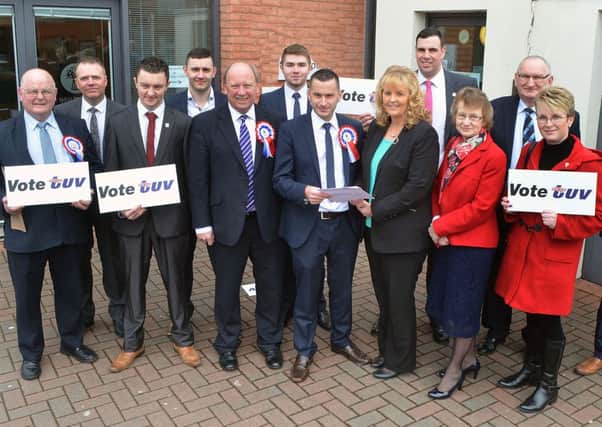 TUV party leader Jim Allister joins party councillors, support workers and Audrey Patterson, election agent; to watch Timothy Gaston hand in his election papers to Rae Kirk, Area Electoral Officer. INBT 15-805H