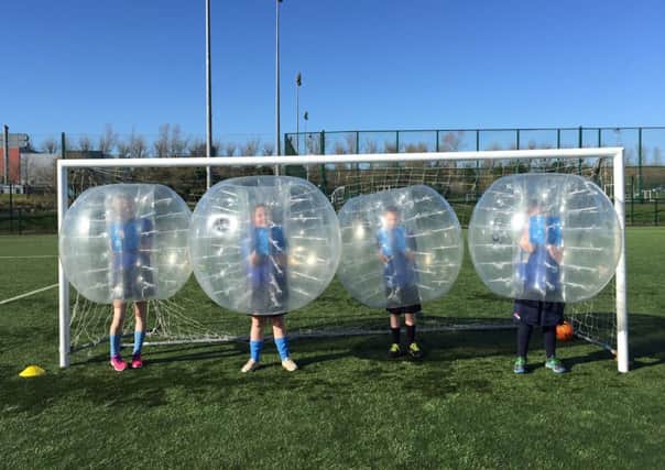 College pupils try out 'bubble ball'.  INCT 15-723-CON