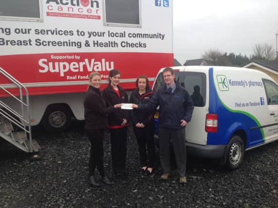 Cathy Powell, Jaimie Welsh and Amy Thompson from Action Cancer NI receiving a cheque from Patrick Kennedy on behalf of the staff and customers of Kennedys Pharmacy, Rasharkin and Dunloy. IONBM16-15 S