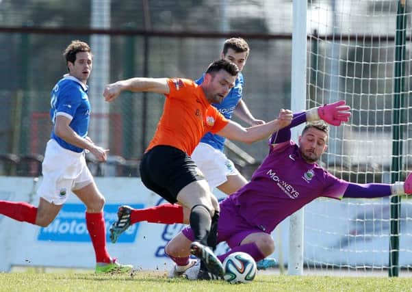 Eoin Bradley gets in a shot against Linfield