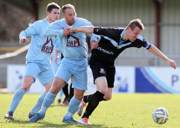 Ballymena United skipper Allan Jenkins escapes the clutches of former United striker Davitt Walsh during Saturday's win at Institute. Picture: Press Eye.