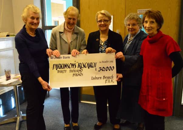 The Lisburn Branch Patron Dame Ingrid Allen and some Branch officers prepare to present a cheque for £30,000 towards a current research project.