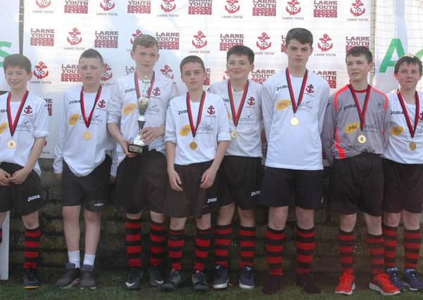 Larne Youth under-14s, winners of the 2001 age group enjoying their success at the recent Larne Youth Soccer Sevens. INLT 16-917-CON