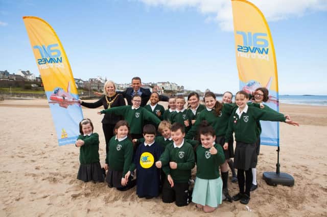 Mayor of Causeway Coast and Glens Borough Council, Councillor Michelle Knight-McQuillan and Chief Executive of Causeway Coast and Glens Borough Council, David Jackson with pupils from St. Patricks Primary School, Portrush at East Strand beach to welcome the RAF Tornado fighter jet.