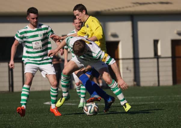 Moyola Park and Lurgan Celtic tussle for the ball