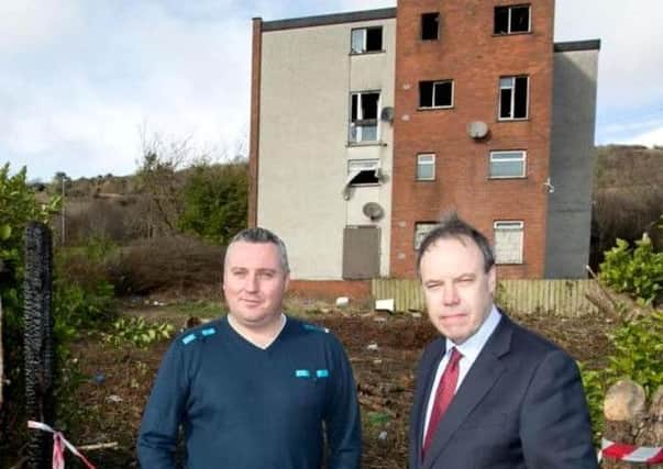 DUP deputy leader Nigel Dodds (right) with local community worker Phil Hamilton outside the derelict flats at Old Irish Highway. INNT 17-504CON