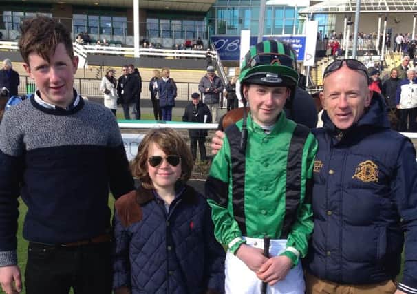 Magherafelt jockey Nathan Evans pictured with his father Paul and brothers
