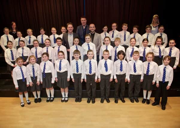 Finalists: Ebrington Primary School choir with their teachers, BBC Radio Ulster presenter John Toal and judges from the BBC Radio Ulster School Choir Of The Year. Photo: Stephen Latimer