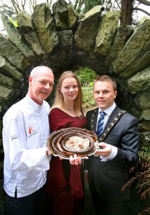 Londonderry chef Emmett McCourt is pictured offering a tempting taste of smoked Lough Neagh Eel to medieval maiden Ingrid Houwers and Councillor Thomas Hogg, Mayor of Antrim and Newtownabbey Borough Council.