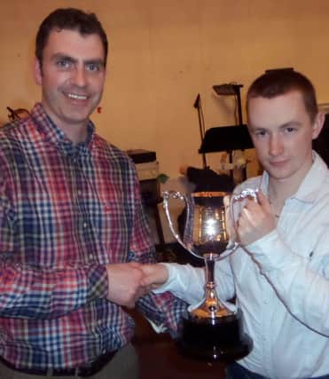 Ballycastle and District Horse Ploughing committee treasurer, Donal McAllister, (left) receiving a new cup donated by fellow committee member, Sean Cassley at the annual dinner in Hunters, Ballyvoy. inbm17-15 kma