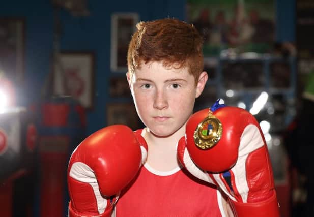 Reece Russell, the new 72kg Irish Champion, shows off his gold medal after returning to his home club - Canal Boxing Club.  US1515-538cd