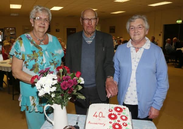 Ninety-three-year-old James Black, who is the oldest member of Broughshane Senior Citizens Club, joined founder member Anne Gilbraith (right) and club chairperson Liz Craig as they cut the club's 40th anniversary cake at last week's celebration dinner in Broughshane Community Centre. INBT 18-104JC