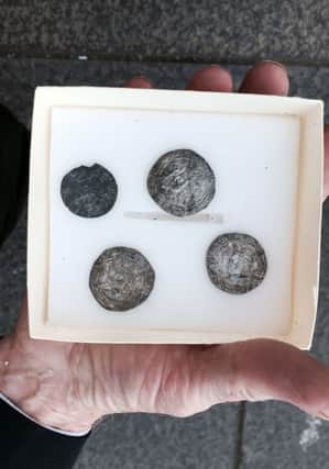 The four 14th century silver coins found by amateur treasure hunter Tom Crawford on land close to Banbridge Co Down, after the coins were declared to be treasure at a hearing at Belfast coroners court. PRESS ASSOCIATION Photo. Picture date: Thursday April 23, 2015. The Scottish groats were unearthed by an amateur treasure hunter who used a metal detector to scour a recently ploughed field near Banbridge in Co Down. In 2001 five similar coins five were discovered in the same area. See PA story ULSTER Treasure. Photo credit should read: Lesley-Anne McKeown/PA Wire