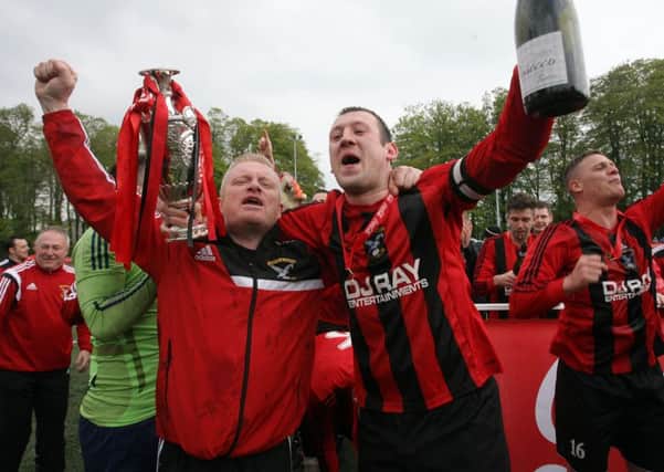 Harryville Homers manager Robert Duddy and captain Gary Bonnes celebrate after lifting the Irish Junior Cup last season. INBT19-316AC