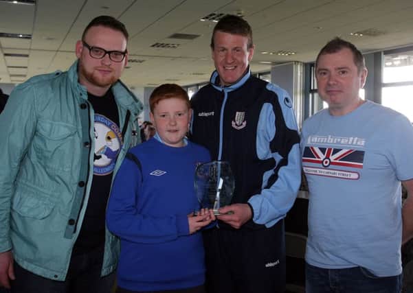 Ethan Gibson presents the Paradise SC Player of the Year award to Allan Jenkins. Also included are Paradie members Rab Russell and Willie Adair. INBT 18-273AC