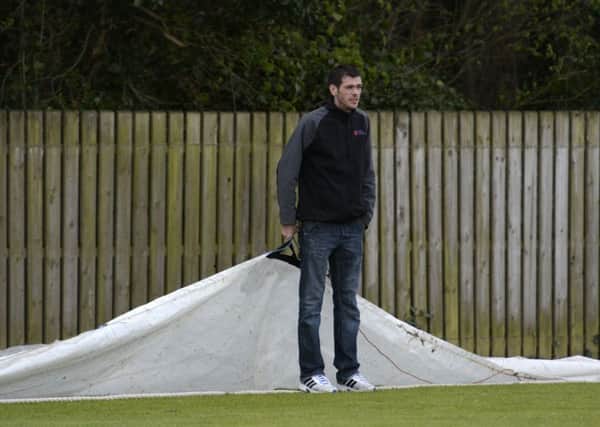 This volunteer stands ready to pull the covers on during the match between the NW Warriors and Ireland Under-19â¬"s at Strabane on Sunday. INLS1715-153KM