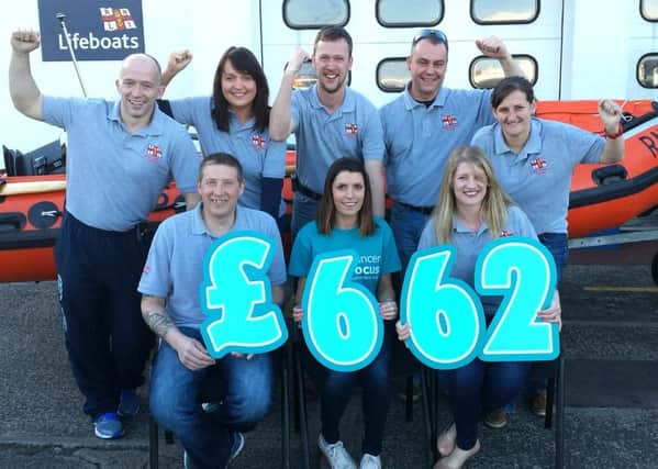 Members of Larne RNLI Crew and Fundraisers who completed the gruelling 5k Obstacle Challenge" Run Mucker Run" raised £662 for their effort  present Emma McArdle from Cancer Focus with a cheque for £662. INLT 16-238-AM