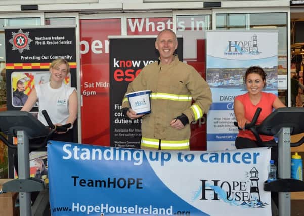 Noel McKee from Whitla Street Fire Station is pictured with Leah McConnell and and Sara Wilson during their spin cycle marathon to raise funds for Hope House. INCT 17-002-PSB