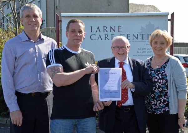 Mr Desmond Wilson (2nd right) owner of Larne Care Centre and the Wilson Group presents a certificate to Gavin Smith on completion of 5 years service at Larne Care Centre also pictured are Leslie Stephens, Nurse Manager and Angela Dorrian, Area Manager. INLT 16-001-PSB