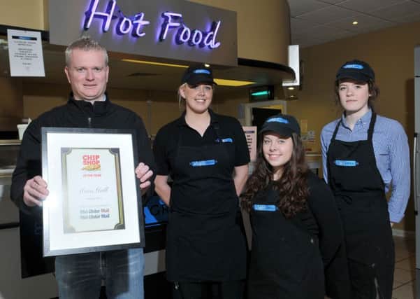 Mark McElwee proprietor of Maxi's Grill Magherafelt winner of the Mid-Ulster Mail Chip Shop of the Year competition proudly displays his award with staff members Jenna Bowman, Aoife McAleenan and Naimh McElwee.INMM1715-337