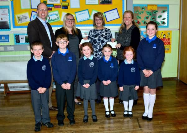 Peter Bovill from 1st Islandmagee Presbyterian, Mrs Todd (Kilcoan PS Principal), Sylvia Gourley (Musical Director 1st Islandmagee Pres.), Mrs Cambridge (Mullaghdubh PS Principal) with Lewis, Dennis, Abigail, Ella, Chloe and Eve from both schools. INLT 18-059-GR