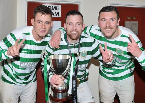 Lurgan Celtic players Chris Lavery,captain Raymond Fitzpatrick and Stephen Hutchinson with the Championship 2 trophy.