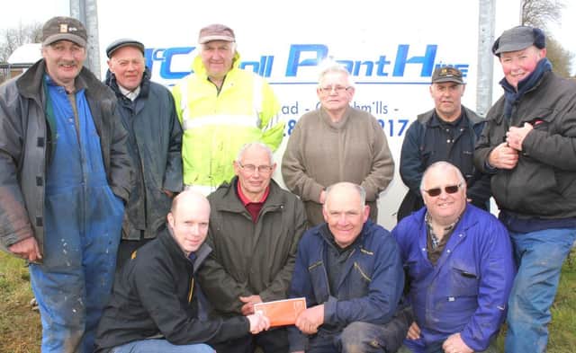 Michael McCarroll, of McCarroll Plant Hire, handing over a sponsorship cheque to members of Cloughmills Vintage for their vintage rally on Saturday June  20th. Back row (from left) Hugh McCormick, Sam Knowles, John Fleming, Dan McToal, Henry Shannon and Robert Baird. Front row (from left)  Michael McCarroll, James McCollum, George McAuley and Seamus Cassley. INBM19-15 S