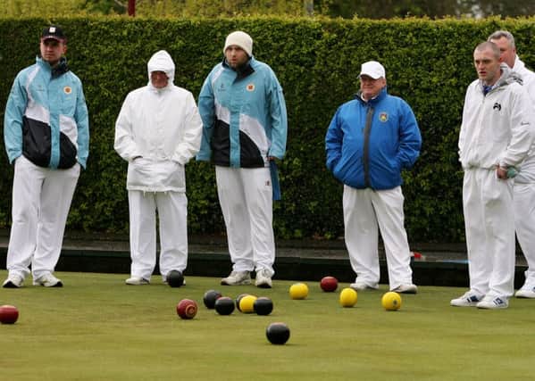 Ballymena A and Ewarts bowlers braving the cold wind and rain during their match on Saturday. INBT19-221AC