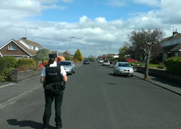 A police officer outside the scene of the security alert  near the gates to the rear of Caw Army Camp, pictured in the background.
