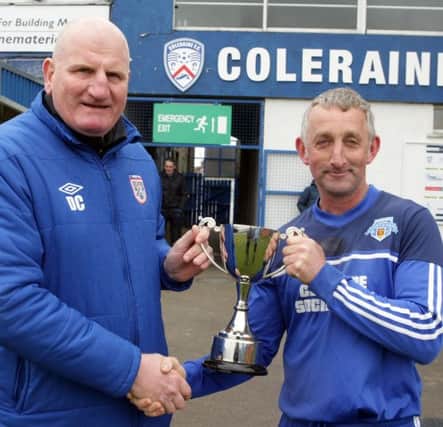 SILVERWARE. Davy Cochrane, Chairman of the Hutchinson Tiles League presents the knock-out cup to cpt of Portrush Old Boys on Saturday following their 1-0 win over Glebe Rangers OB.CR19-050SC.